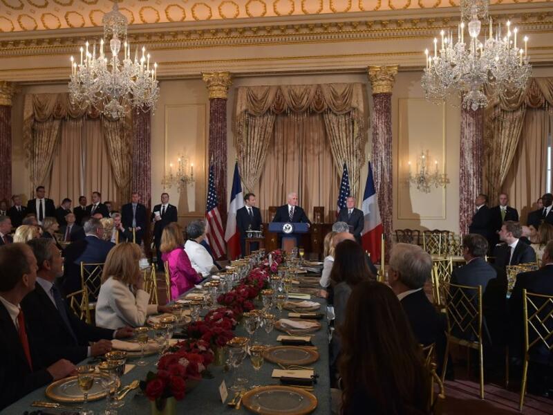 French President Emmanuel Macron (L) looks on as US Vice President Mike Pence speaks during a luncheon at the US State Department in Washington, DC on April 24, 2018. 
Andrew CABALLERO-REYNOLDS / AFP

