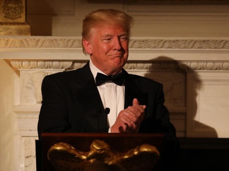 US President Donald Trump applauds during the State Dinner for French President Emmanuel Macron at the White House in Washington, DC, April 24, 2018. 
Ludovic MARIN / AFP