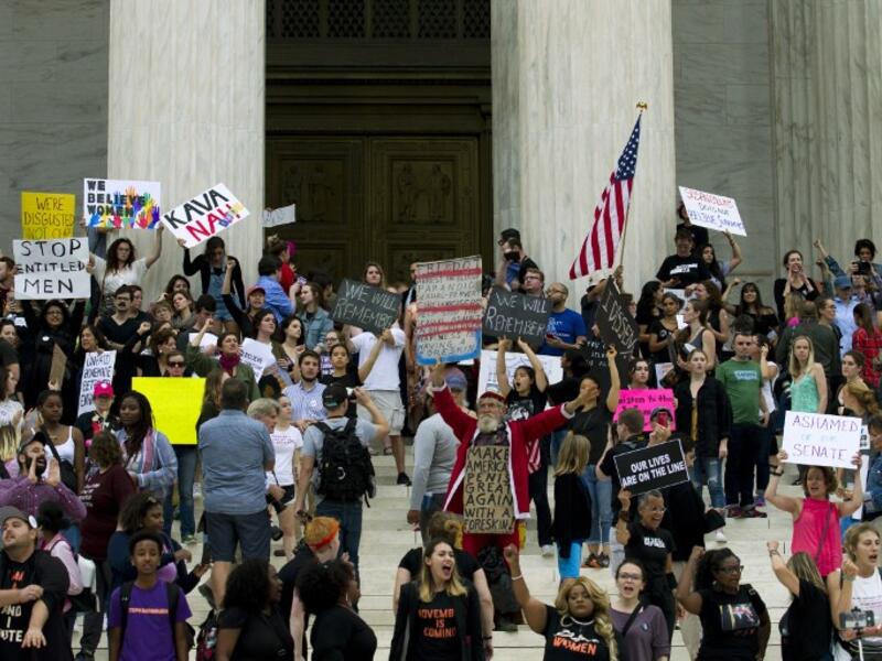 Demonstrators take the steps of the US Supreme Court to protest against the appointment of Supreme Court nominee Brett Kavanaugh in Washington DC, on October 6, 2018. (Jose Luis Magana / AFP)

