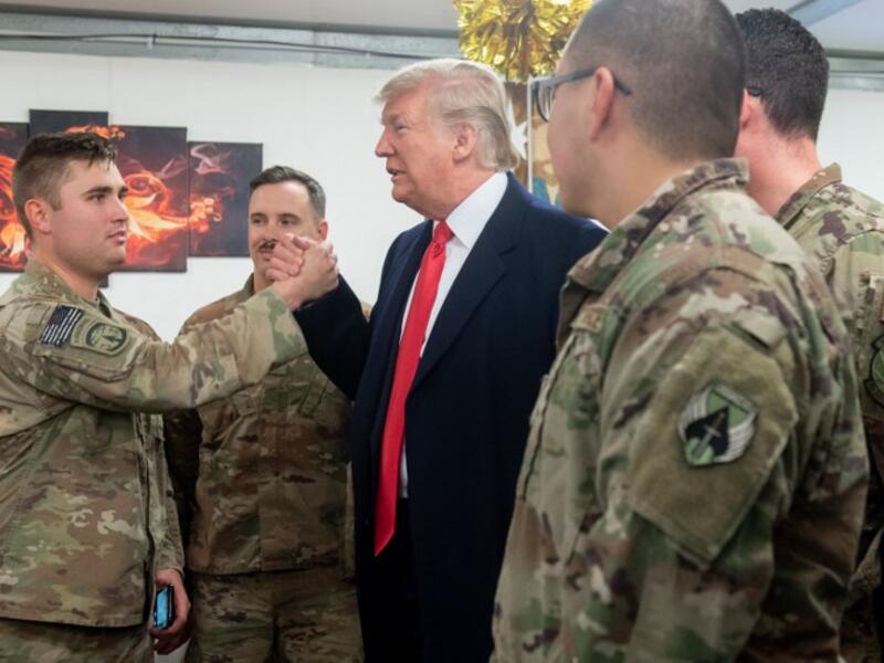 US President Donald Trump greets members of the US military during an unannounced trip to Al Asad Air Base in Iraq on December 26, 2018. 
SAUL LOEB / AFP