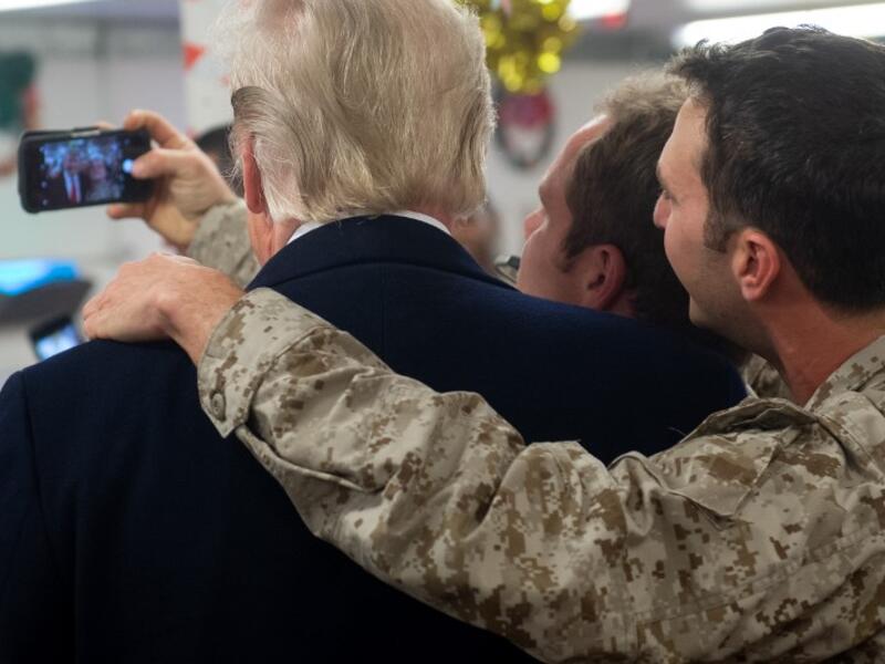 US President Donald Trump greets members of the US military during an unannounced trip to Al Asad Air Base in Iraq on December 26, 2018. SAUL LOEB / AFP