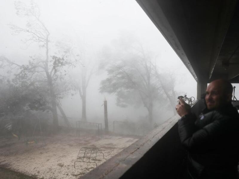 Derik Kline takes shelter in a parking garage as Hurricane Michael passes through the area on October 10, 2018 in Panama City, Florida. (Joe Raedle/Getty Images/AFP )