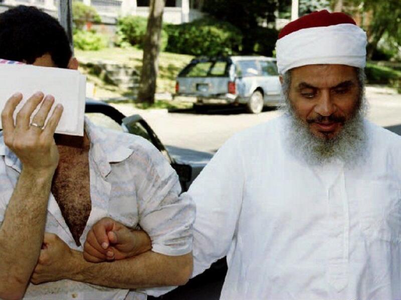 This file photo taken on June 25, 1993 shows Sheikh Omar Abdel-Rahman (R) entering his apartment building with an unidentified man after afternoon prayers at his mosque in Jersey City, New Jersey. (AFP/Mark D. Phillips)