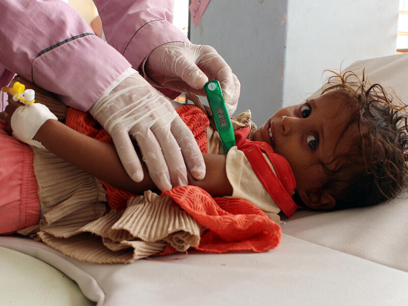 A Yemeni child suspected of being infected with cholera is checked by a doctor at a makeshift hospital. (AFP) 