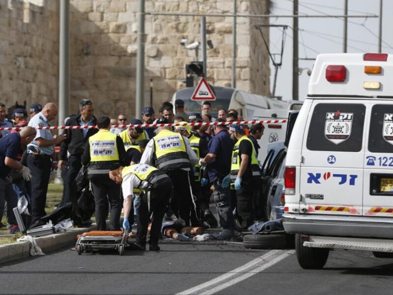 Israeli emergency personnel and security forces gather at the scene of an attack outside Jerusalem's Old City's New Gate on March 9, 2016. (AFP/Ahmad Gharabli)