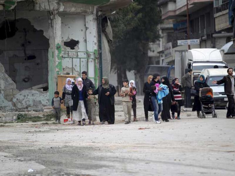 People walked through a bombed street in Daraa. (AFP/File)