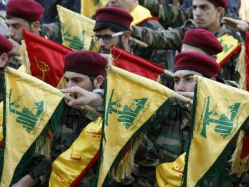 Members of Lebanon's Shia movement Hezbollah hold their flags during the funeral of a Hezbollah fighter, who was killed while fighting alongside Syrian government forces in Syria, March 1, 2016. (AFP/Mahmoud Zayyat)