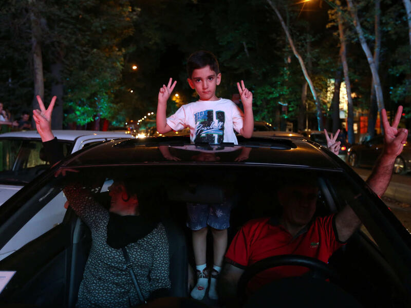 A family celebrates in the streets of Iran's capital Tehran after news of the recent nuclear deal.  (AFP/Atta Kenare)