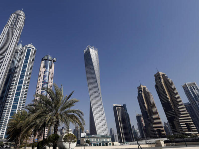 The Cayan tower (C), the world's tallest twisted tower stands at Dubai's Marina on June 11, 2013 in the United Arab Emirates, UAE. (AFP/KARIM SAHIBSAHIB)