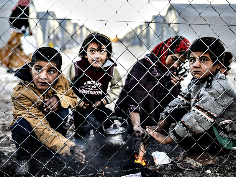 A Syrian Kurdish woman and her children wait in a refugee camp in Turkey. (AFP/Bulent Kilic)