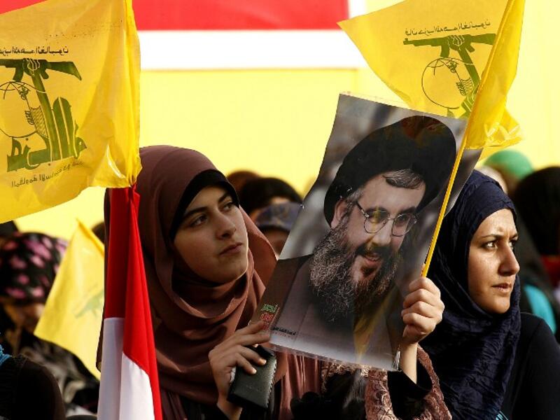 A woman holds a photo of Hizbollah leader Hassan Nasrallah (Source: AFP file photo)