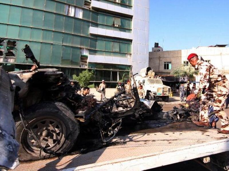 An Iraqi soldier loads the wreckage of a car bomb from the shrine city of Karbala, southwest Baghdad, on Thursday, the deadliest day for Iraq in more than two months. (AFP PHOTO)