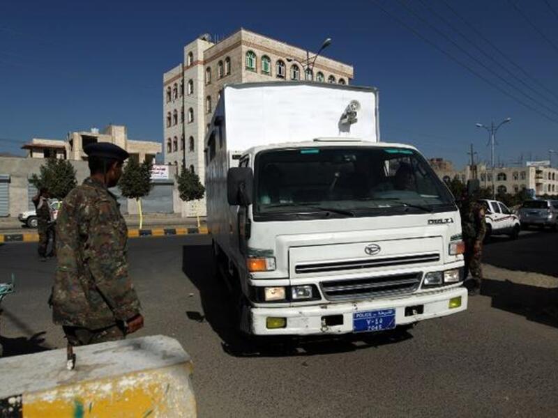 Yemeni soldiers stand guard outside the state security court as suspected Yemeni al-Qaeda militants arrive in a truck for their trial. (AFP PHOTO/ MOHAMMED HUWAIS)