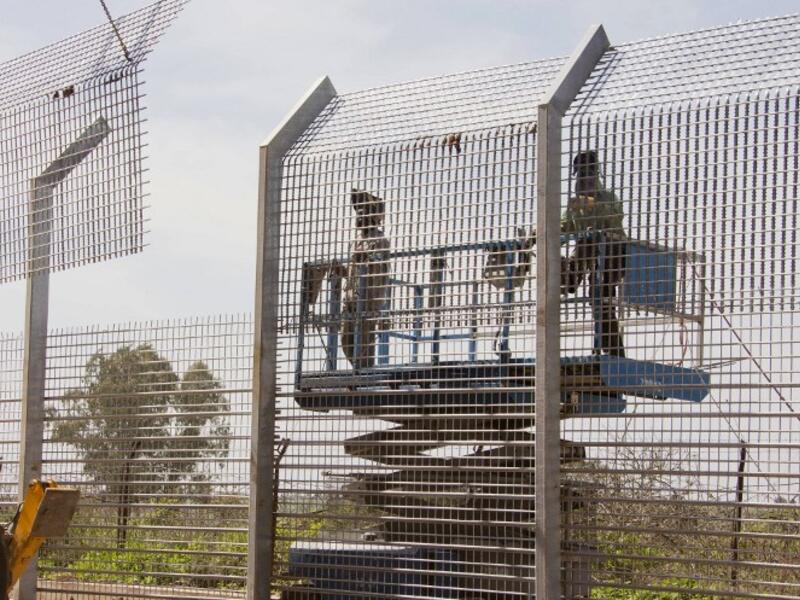 Laborers work at the construction site of a border fence along Israel's border with Syria in the Golan Heights. (AFP PHOTO/JACK GUEZ)