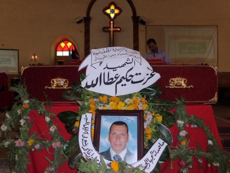 The coffin of Ezzat Hakim Attallah (portrait), who died in the eastern Libyan city of Benghazi, days after being arrested on charge for allegedly seeking to convert Muslims in Libya, is seen during his funeral service at a church in Assiut city, 386 kilometers south of Cairo, on March 13, 2013. (AFP PHOTO / STR)