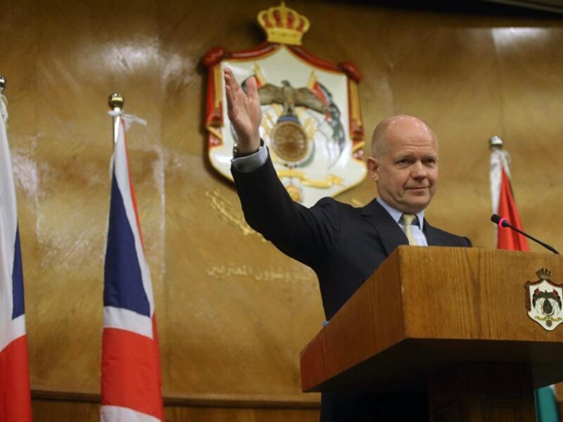 British Foreign Secretary William Hague waves during a press conference in Amman on May 22 (AFP)