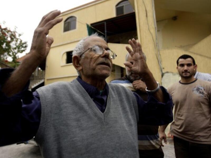 The family of Mohammed Adnan, a suspect in the bombing of the Iranian embassy in Beirut, have disavowed the alleged suicide bomber along with the Palestinian leadership. Here, his grandfather reacts in front of the building where his family lives (AFP)
