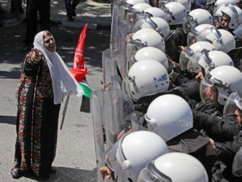 Palestinian police with riot gear stand guard as they stop supporters of the Popular Front for the Liberation of Palestine (PFLP) from reaching the headquarters of president Mahmoud Abbas. (AFP).
