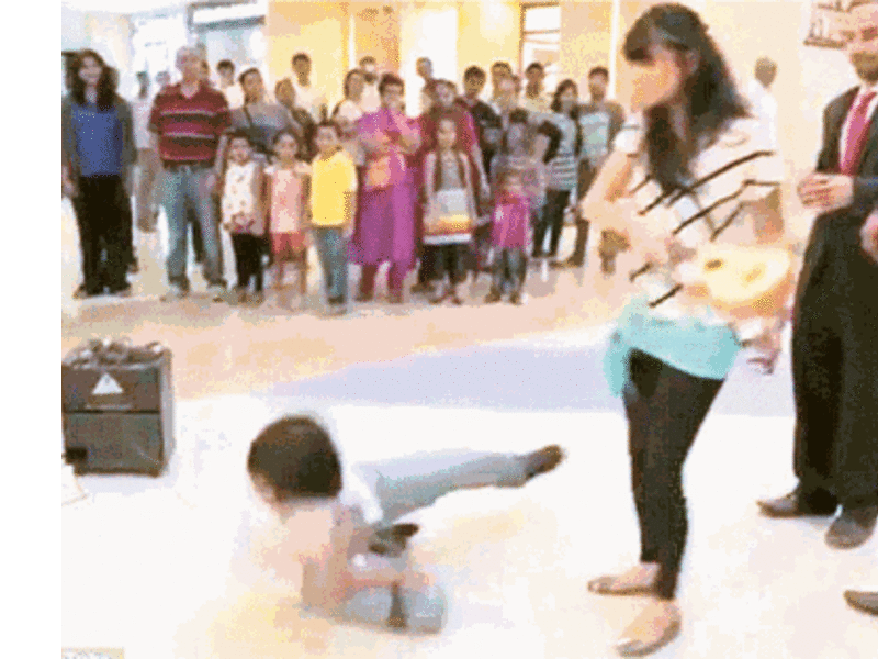 The man lies on the floor after being hit round the head with a small guitar. Not an ideal end to any proposal. But was the video real or fake? (YouTube)