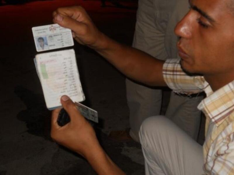 Alaa shows us his tainted ID card