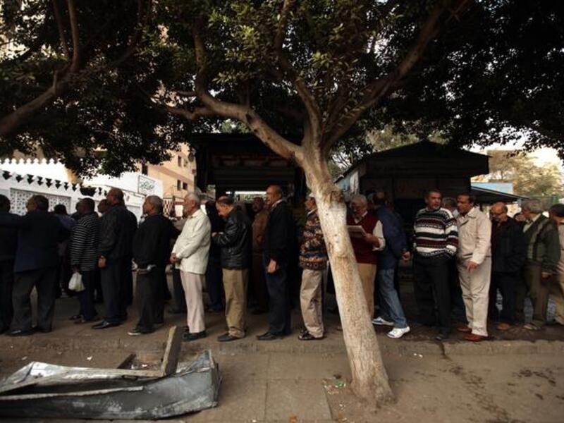 Egyptian men partake in the referendum, at a polling station in Cairo  to cast their votes on a new constitution, December 15