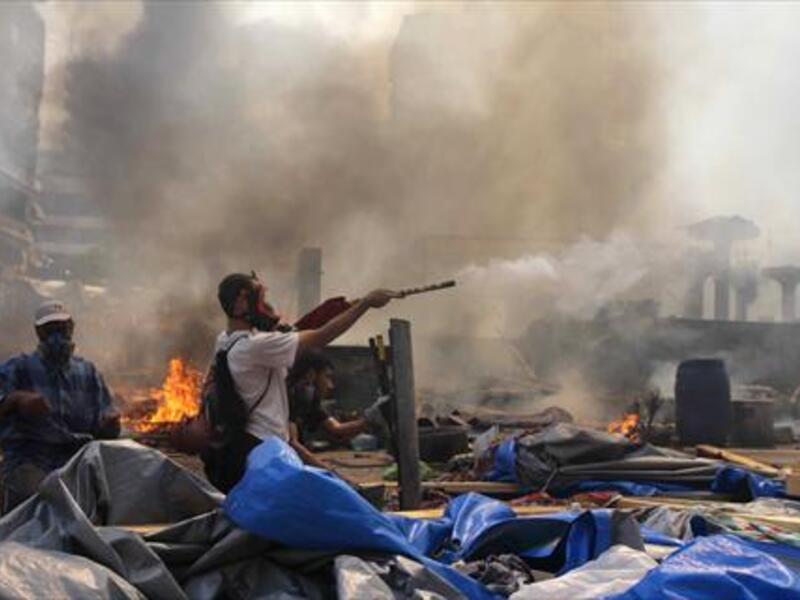 A supporter of the Muslim Brotherhood and Egypt's ousted president Mohamed Morsi fires fireworks towards police during clashes in Cairo on Wednesday. (AFP)