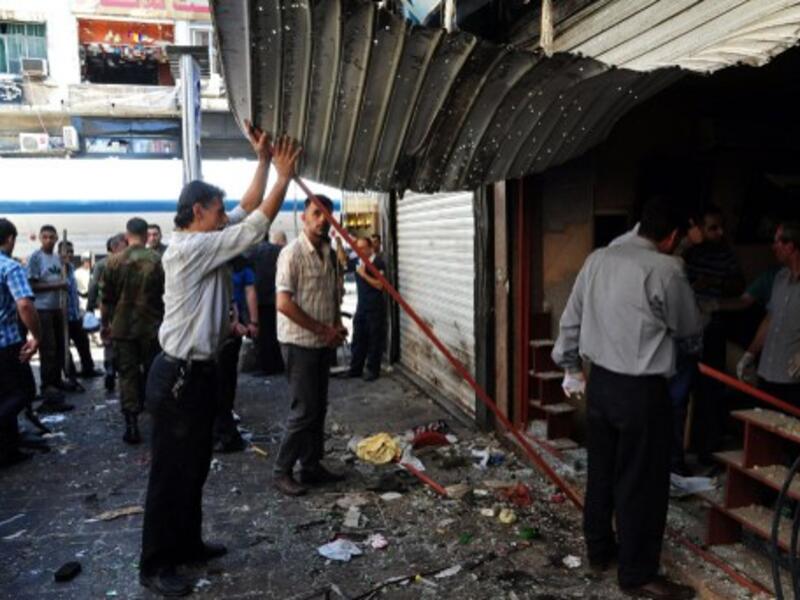 Syrians inspecting the damage in central Damascus following two explosions on Tuesday. AFP photo