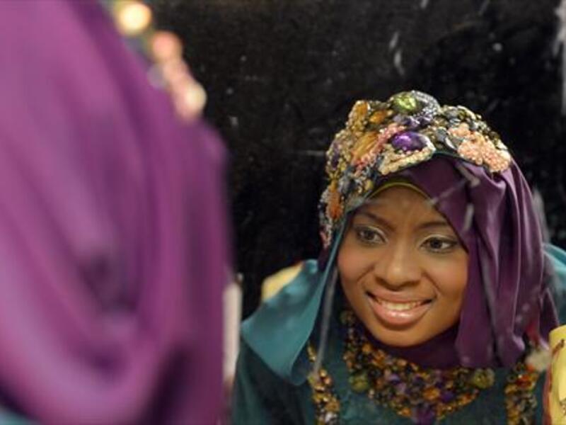 Obabiyi Aishah Ajibola, a 21-year-old contestant from Lagos, looks in the mirror shortly before winning the Miss Muslim World competition. (AFP)