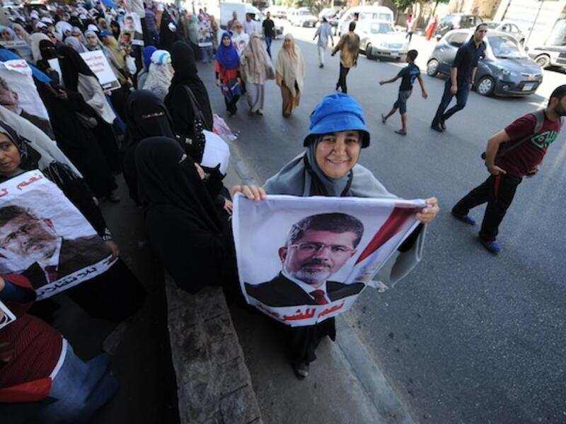 An Egyptian supporter of deposed president Mohamed Morsi holds a portrait of him during a demonstration against the government in al-Nasr street in Cairo on July 30, 2013. (AFP)