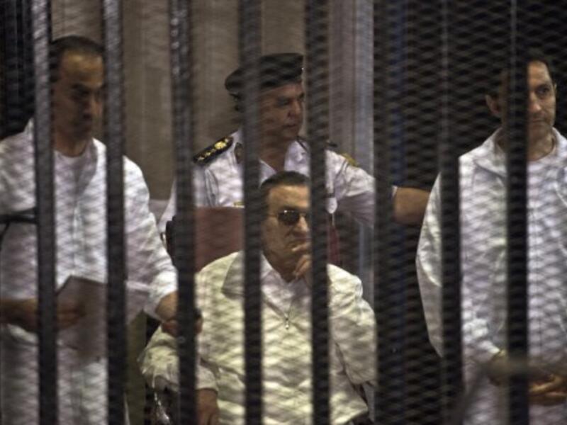 Ousted Egyptian president Hosni Mubarak (C) and his two sons Alaa (R) and Gamal (L) are seen behind the defendents' cage during their retrial at the Police Academy in Cairo on Saturday. The sons have now been released. AFP photo
