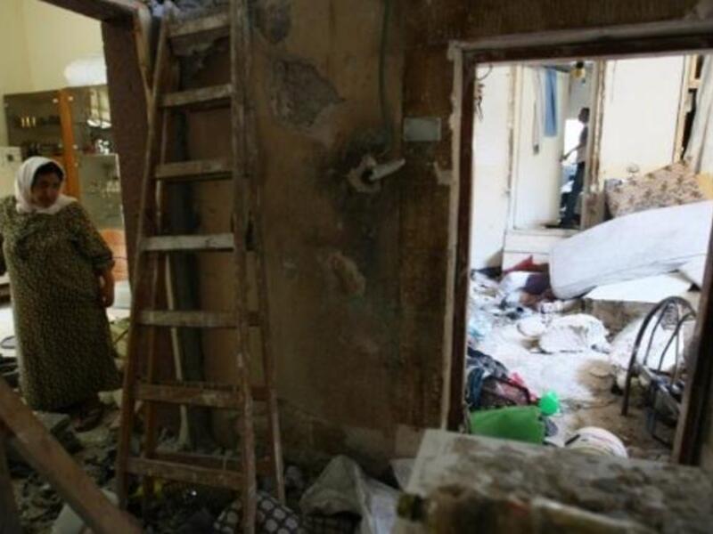 One woman stands in the wreckage of her home in Nablus