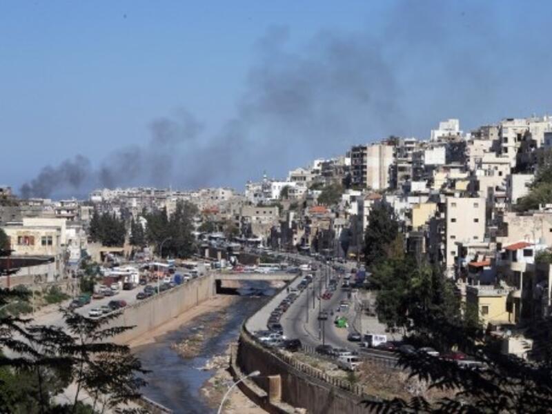 Smoke rises from above Tripoli's predominantly Sunni Bab Al-Tabbaneh neighborhood following days of fatal clashes with the Alawite neighborhood of Jabal Mohsen (Joseph Eid/AFP)