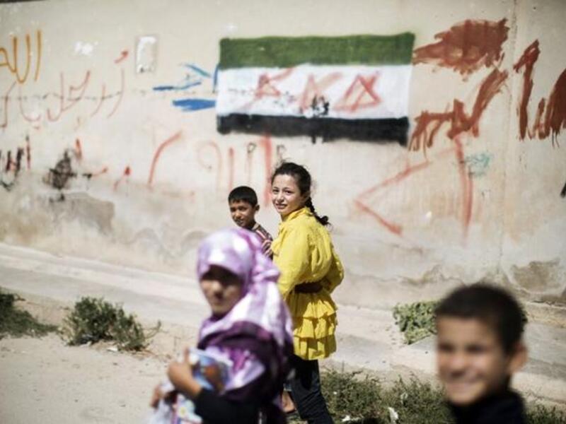 Children walk home from an improvised school in Azaz (AFP)