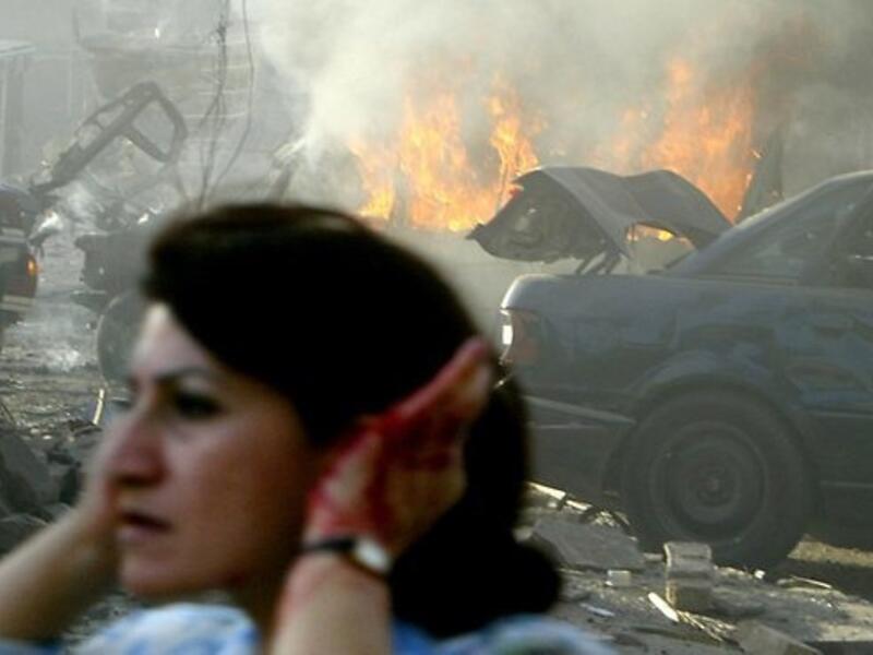 A woman holds her ears while fleeing one of the many car bomb atacks that have targeted Middle East countries over the past year (AFP)