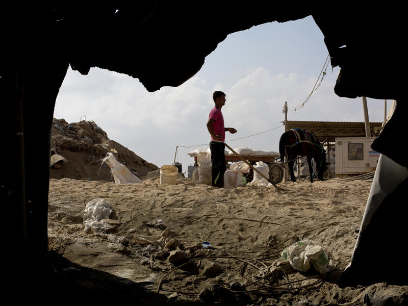  A Palestinian worker stands at the entrance to smuggling tunnels along the Gaza-Egypt border on July 19. AFP / MOHAMMED ABED