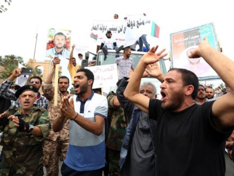 Libyan protesters hold placards and banners during a demonstration in support of the "political isolation law" in Libya's landmark Martyrs Square on May 5, 2013 in Tripoli, Libya. (Photo: AFP / Mahmud Turkia) 