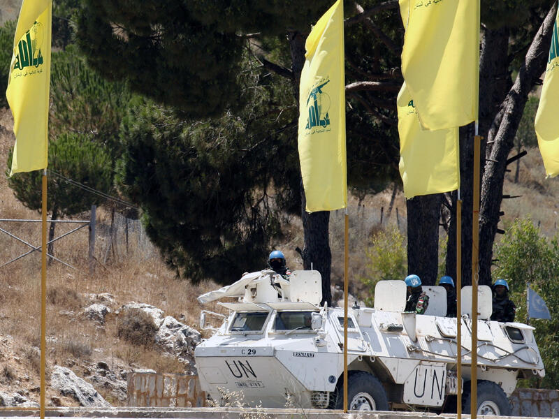 UN peacekeepers patrol past Hezbollah flags on July 23. (AFP / Mahmoud Zayyat)