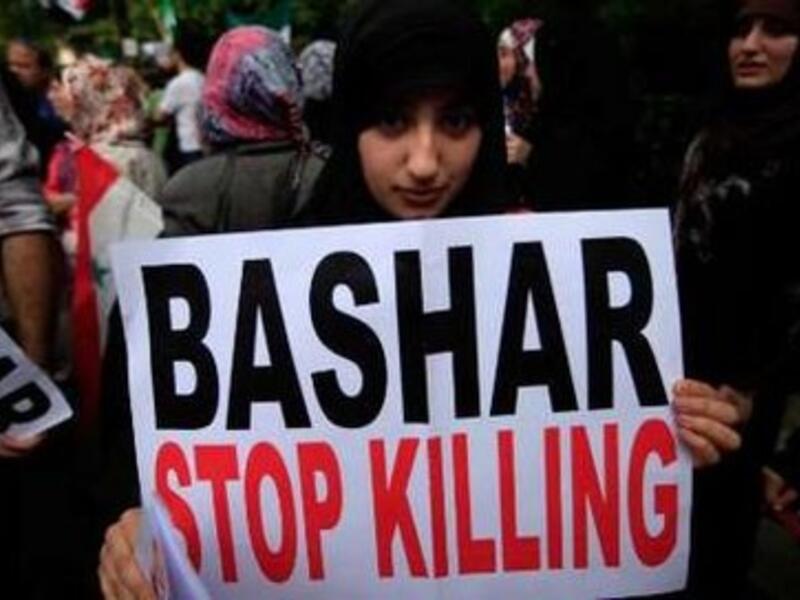 Is America really only limited to signs and banners to stop Bashar Assad?