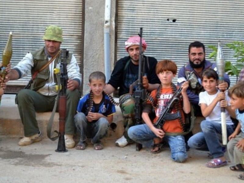 Members of the FSA pose with local children 