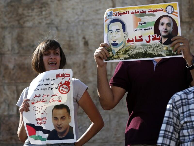 Palestinian protestors hold posters of Bilal Kayed, protesting his administrative detentio at Damascus Gate, a main entrance to Jerusalem's Old City. (AFP/Ahmad Gharabli)