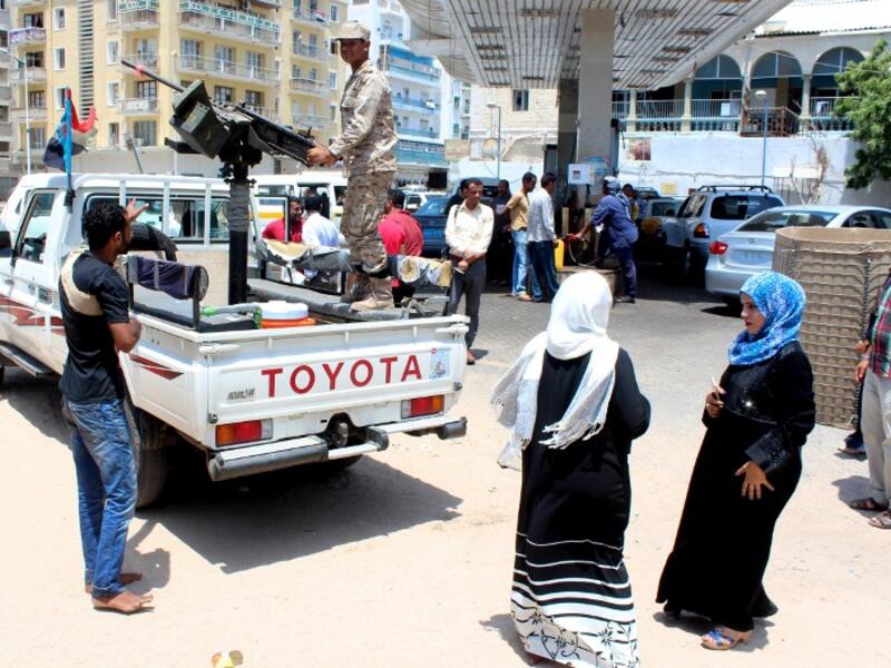 A Loyalist soldier observes the crowd at a gas station in Aden, Yemen. (AFP/File)