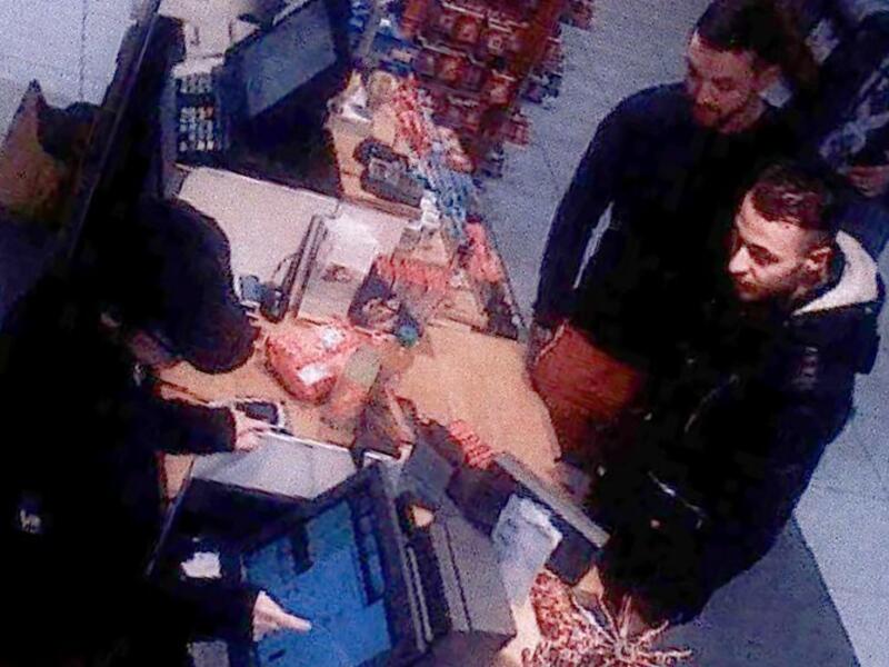 This file video image taken from a CCTV camera at a petrol station north of Paris on November 11, 2015 shows Salah Abdeslam (R), a suspect in the Paris attacks, and Mohamed Abrini (C) buying goods. (AFP/File)