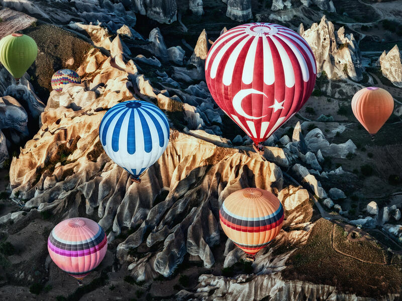 Colorful hot air balloons over mountain landscape in Cappadocia, Goreme National Park Turkey (Shutterstock/File Photo)