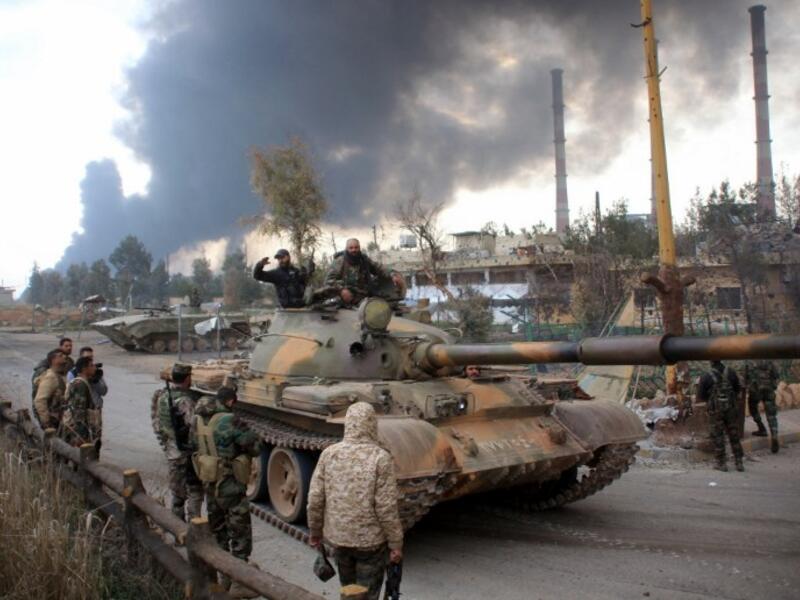 Syrian government forces patrol near Aleppo's thermal power plant after they took control of the area on the eastern outskirts of Syria's northern embattled city from Islamic State (IS) group fighters on February 21, 2016. (AFP/George Ourfalian)