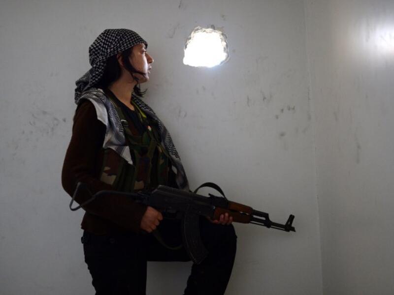 In Aleppo Kurdish soldiers have been a major influence in the fight against both Daesh and the regime. "We’re not just a pretty picture. We are a way of thinking," YPJ Gen. Narin Afrin told FT Magazine. Here a woman watches government forces through the wall in the central city. (AFP/Dimitar Dilkoff)