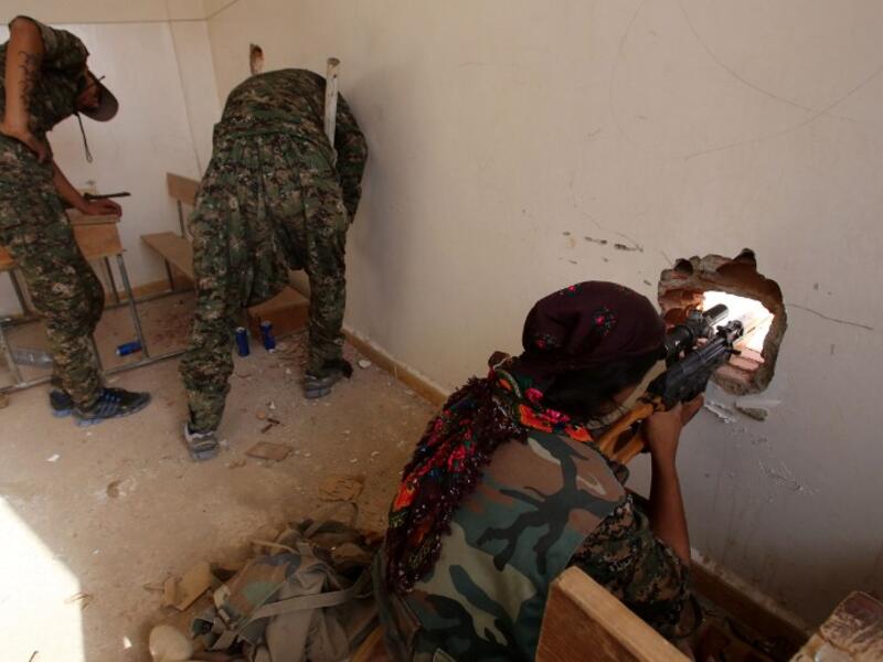 Kurdish forces position themselves inside a classroom on July 16, 2015. (AFP/File)