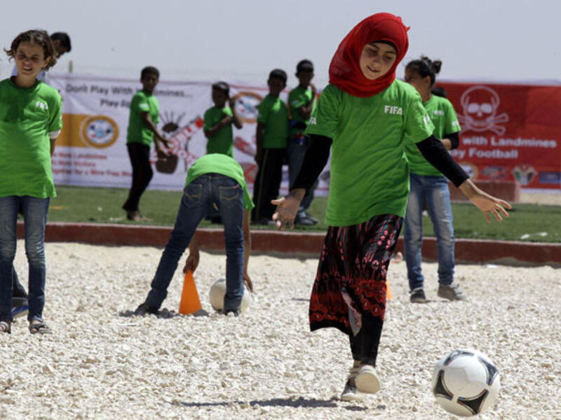 Syrian children play a football match in Jordan's Zaatari refugee camp on July 6, 2013.  (AFP/Khalil Mazraawi)