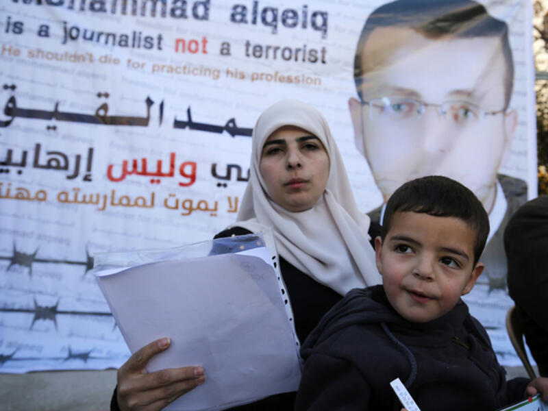 Mohammed al-Qiq's wife, Fayha Shalash and her son Islam, on 31 January, 2016  (AFP/File)
