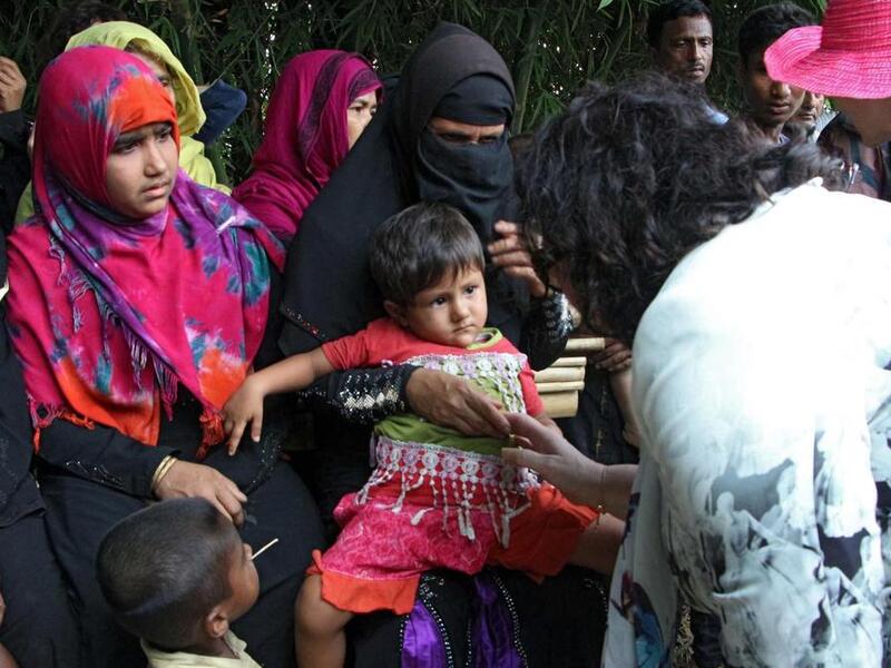 The high-level 15-member delegation of the UN Security Council talk to Rohingya refugees during their visit to Tombru in the Bangladeshi district of Bandarban on April 29, 2018. AFP