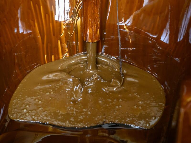 Naftalan crude oil flows from a tap to fill a bathtub during a treatment session at Sehirli Naftalan Health Center, some 300 kilometres (186 miles) from capital Baku, on March 21, 2019. Immersed up to her neck in crude oil, a Russian woman suffering from joint disease smiles in delight, confident that the treatment at a spa in northwestern Azerbaijan will cure her painful condition.  Mladen ANTONOV / AFP